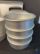 Assortment of Cake Pans and Cake Displays with Domes