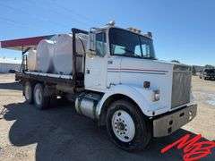 1986 White Flatbed Truck w/ (2) 925 Gallon Fertilizer Tanks and (1) 535 Gallon Fertilizer Tank